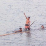 Boys in canoes hamming it up for the camera